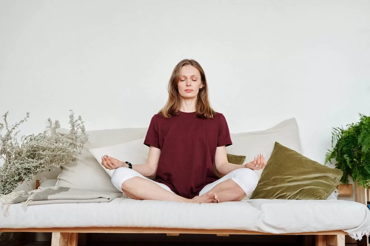 A young woman meditates in order to regulate her nervous system easily